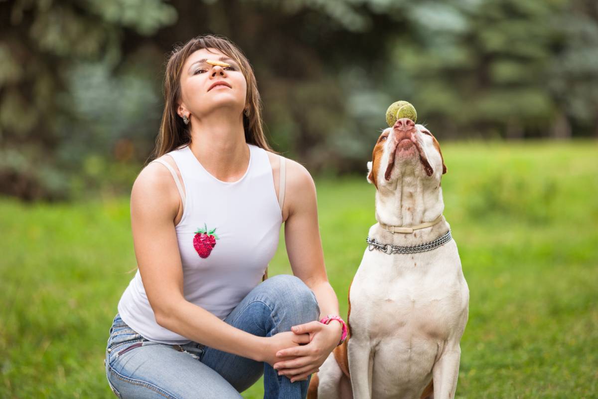 Beautiful woman playing with dog.